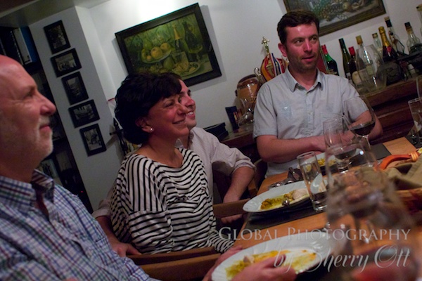 Guests share stories around the communal table