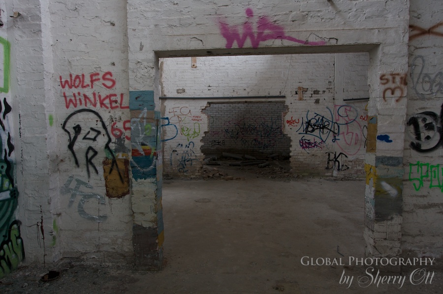 An abandoned building is riddled with tags
