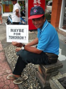 Taxi driver holds sign that says 'maybe tomorrow?'